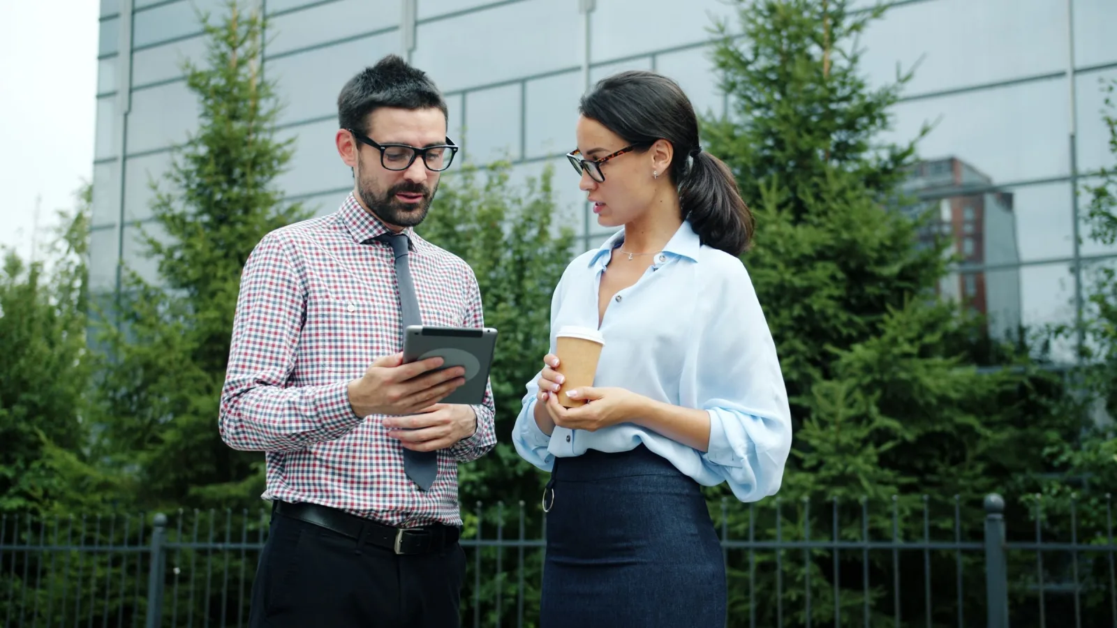 Home-service professionals reviewing project terms together on a tablet