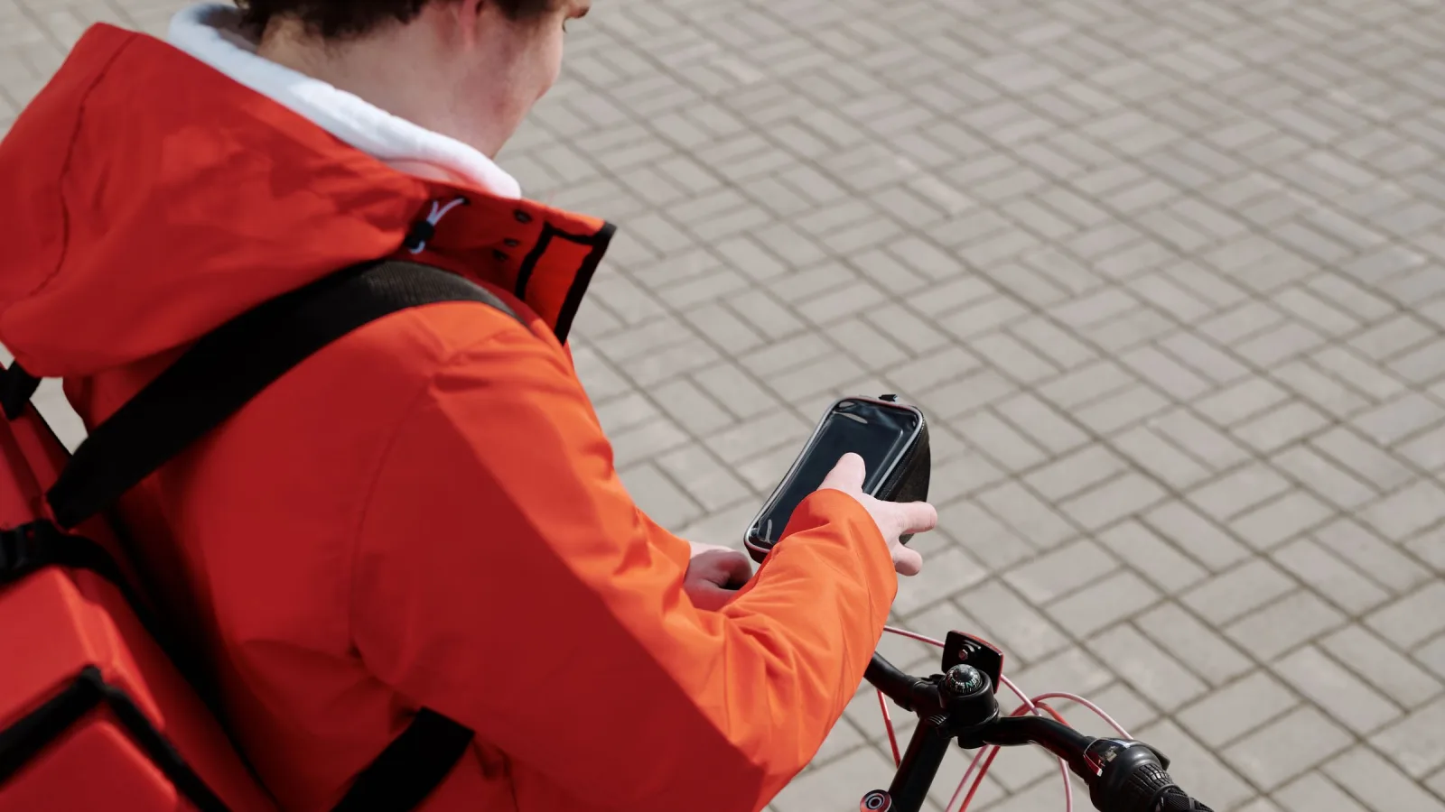 Worker beside a bicycle looking at a phone