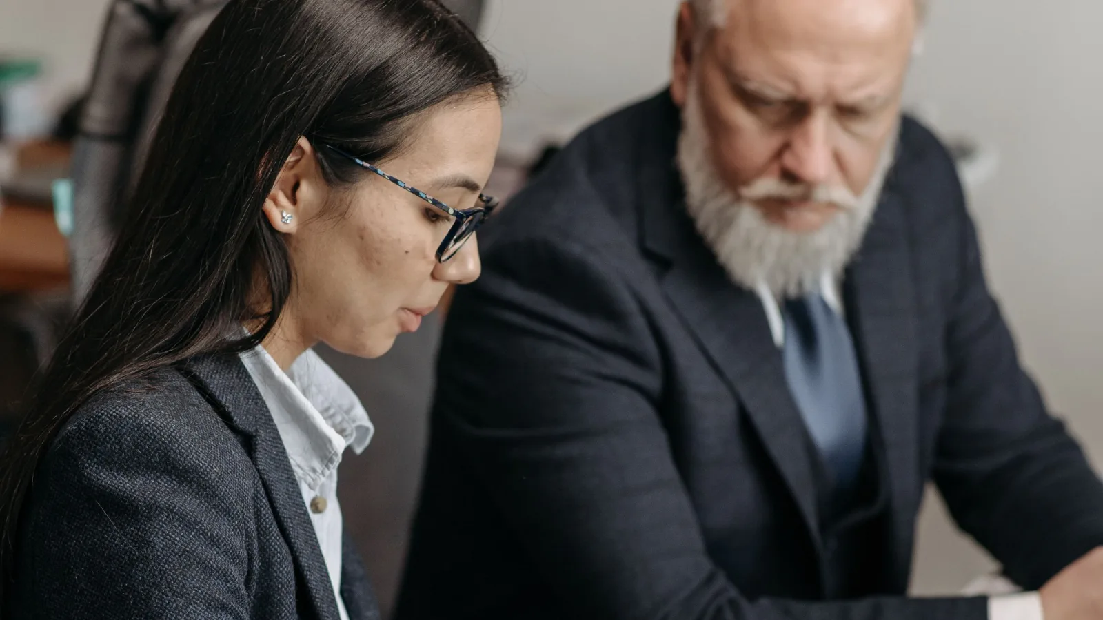 Two people looking down together in an office