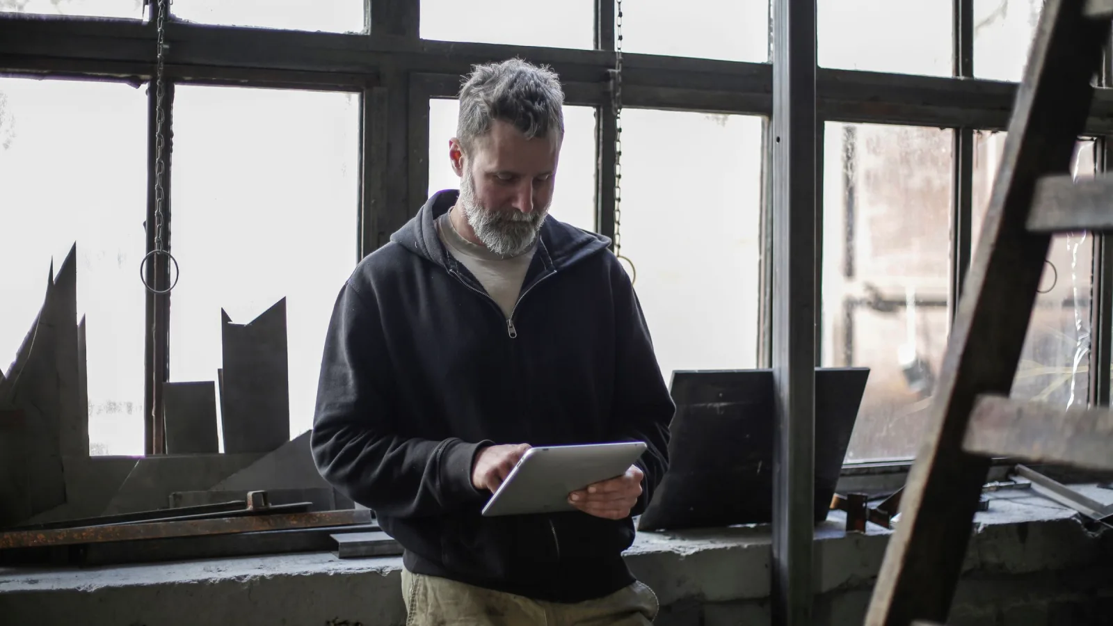 Workshop operator reviewing service details on a tablet
